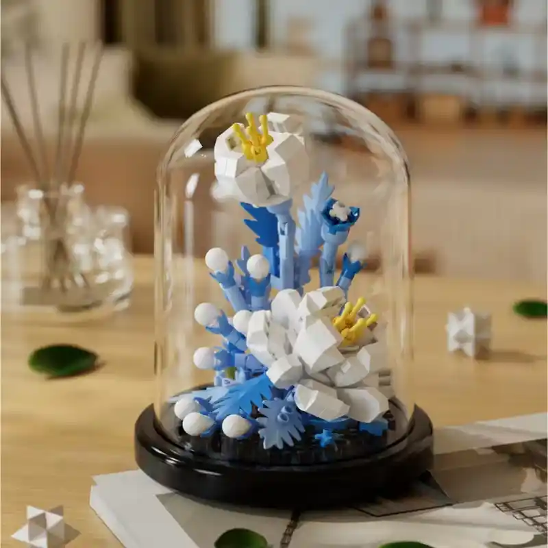 A Paeonia flower made from building blocks in a domed terrarium.