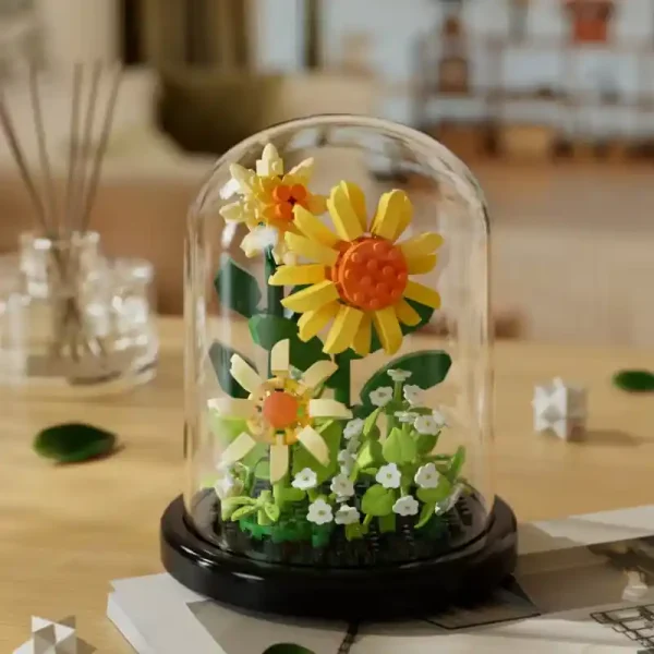 A sunflower made from building blocks in a domed terrarium.