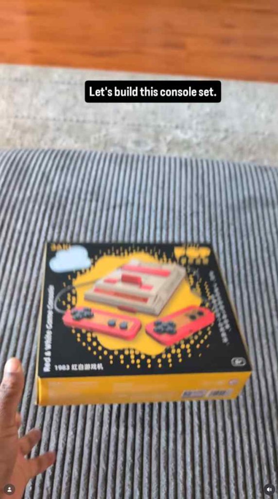 Boxed building blocks set held over a striped rug